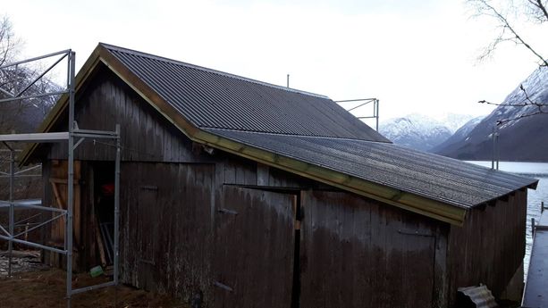 En hytte / uthus som har fått nytt tak 